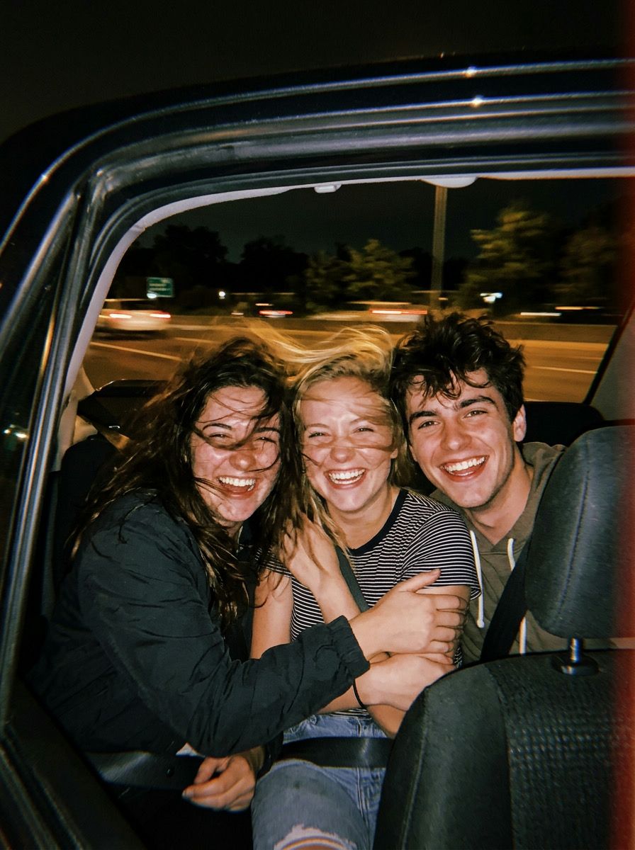 Friends in the back seat on a road trip